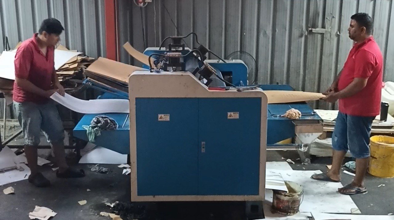 Two FirstPack operators feeding the gluing and stitching machine