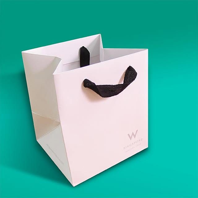 White boutique paper bag with black rope handles